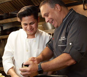 Carmine's executive chef laughing with line cook
